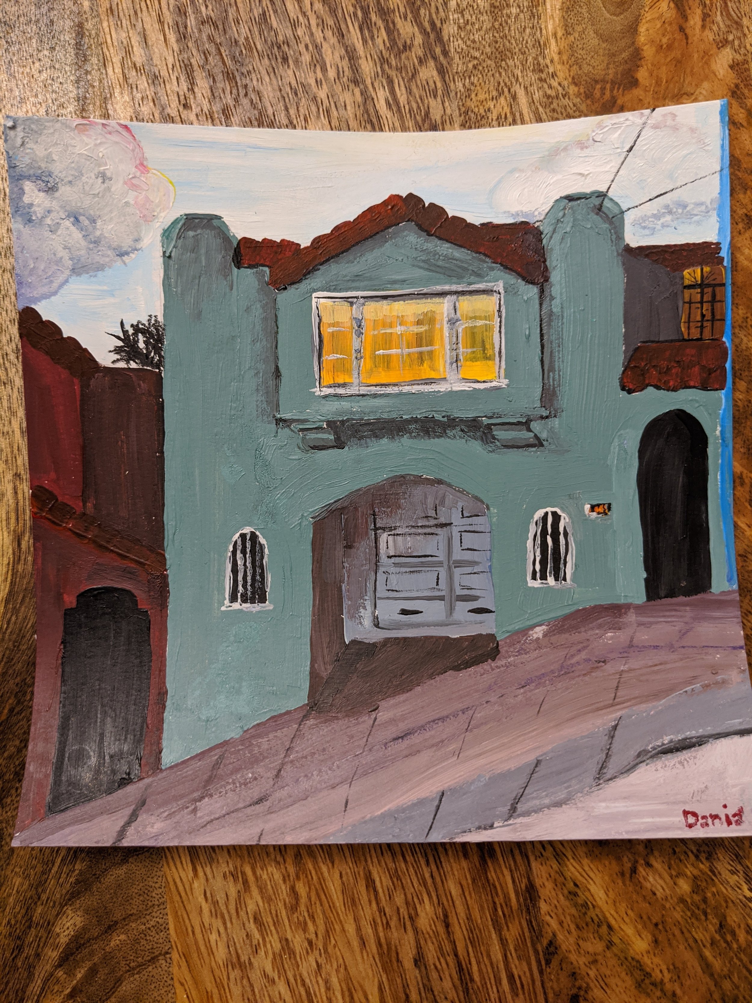 Painting of a two-story green house with yellow-lit windows, red roof, and two arched windows on the front, signed by Daria.