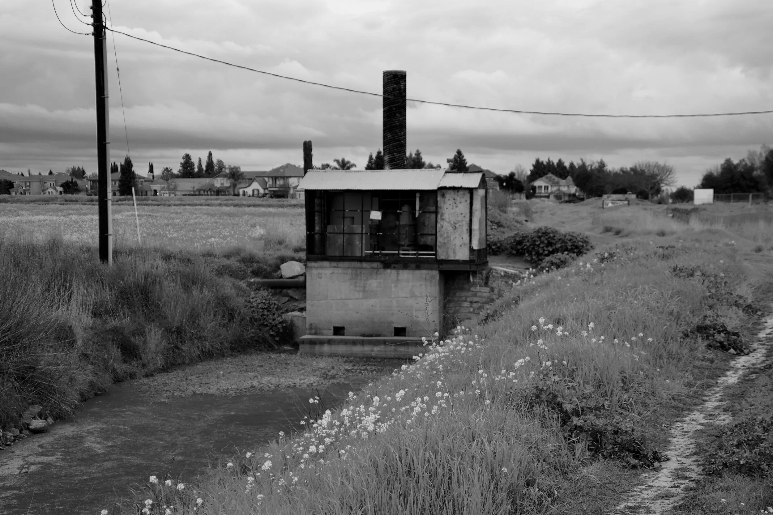 Creekside Pump House


A quiet rural scene featuring an old pump house beside a winding creek under dramatic skies. Professionally photographed by SNHPhoto. Available as premium prints, canvas, metal, and framed wall art.