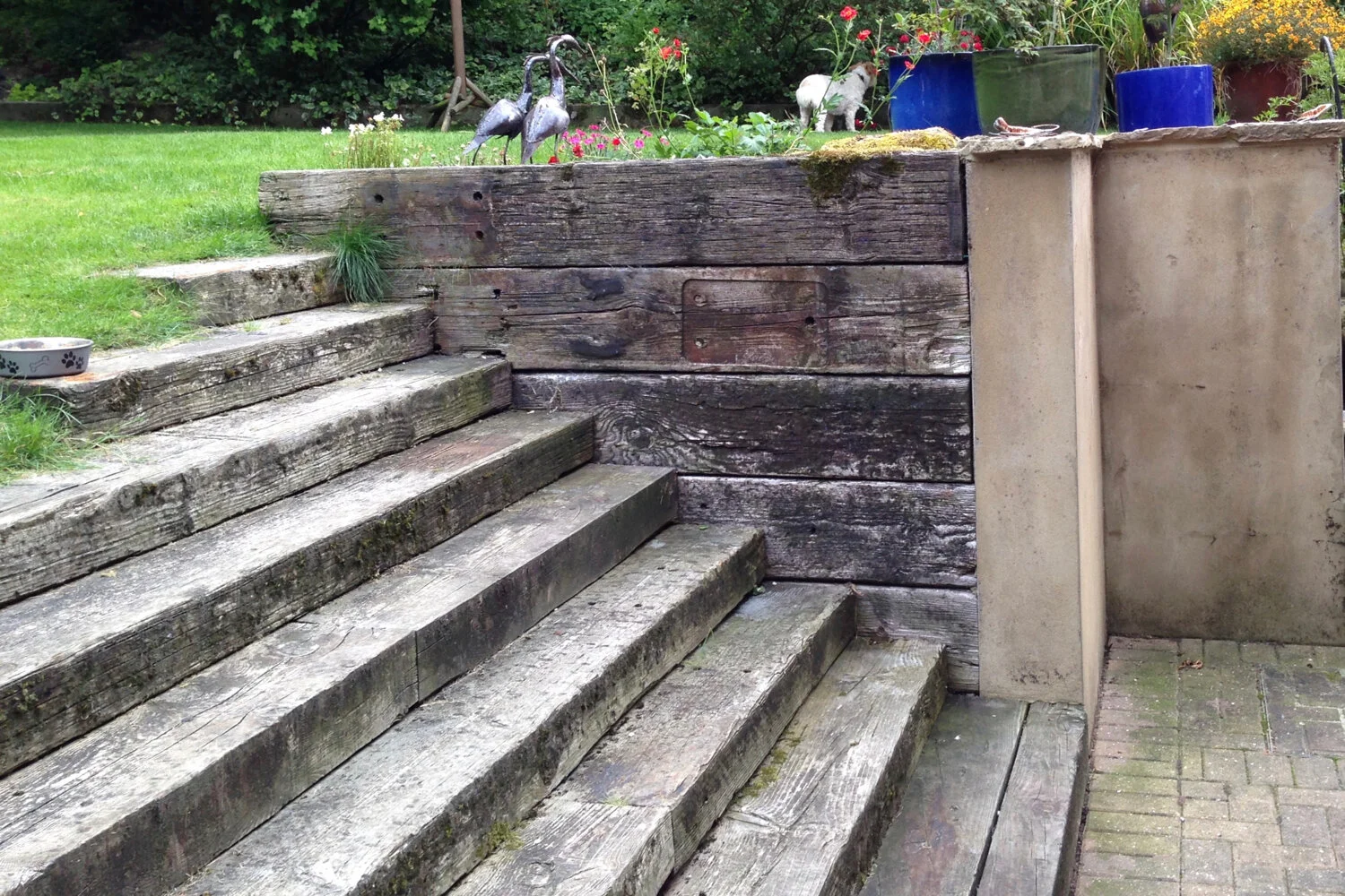Working with levels, worn timber sleepers blend softly in the environment.