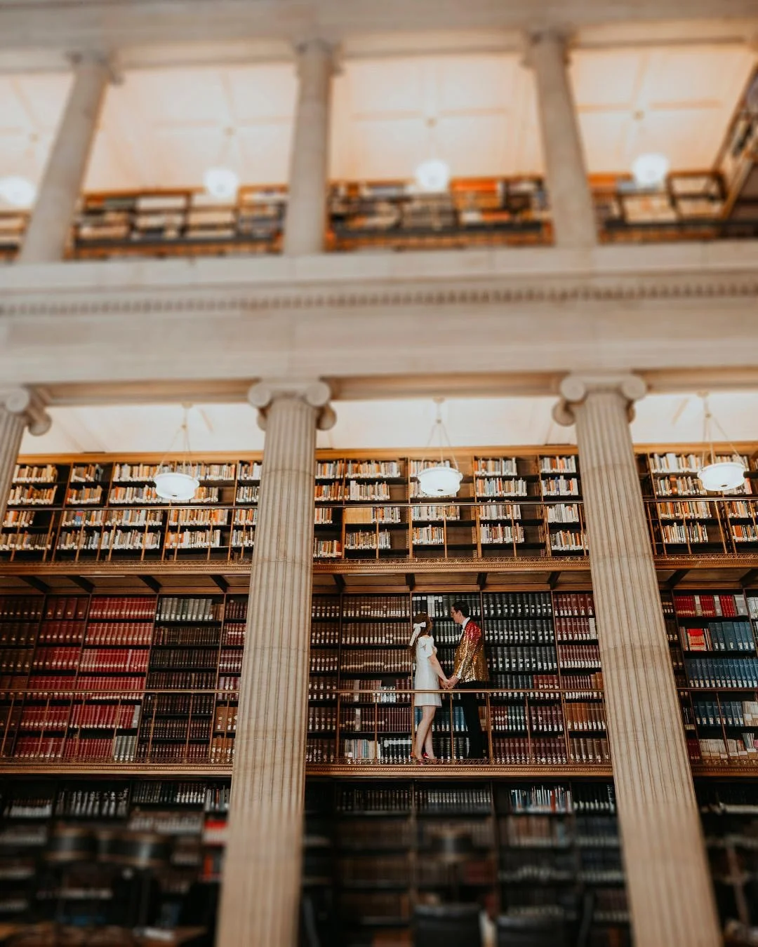 A love story dressed in sequins and shine.
At the newly reimagined James J. Hill Library, they didn’t just elope—they staged a takeover. Rainbow heels hitting marble floors. A jacket sparkling in the soft light. Every glance, every step,