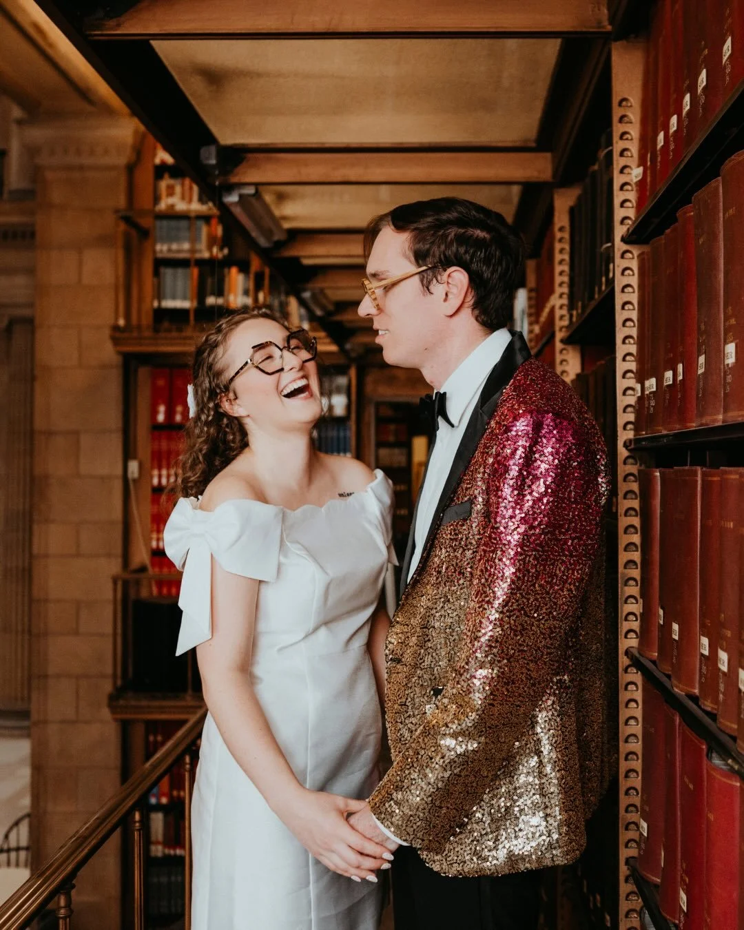 An intimate ceremony tucked inside the @avalonsaintpaul surrounded by towering shelves of books, quiet academia, and the kind of history you can feel in the walls.
They came in wearing sequins and bows, rainbow shoes flashing as they moved through th