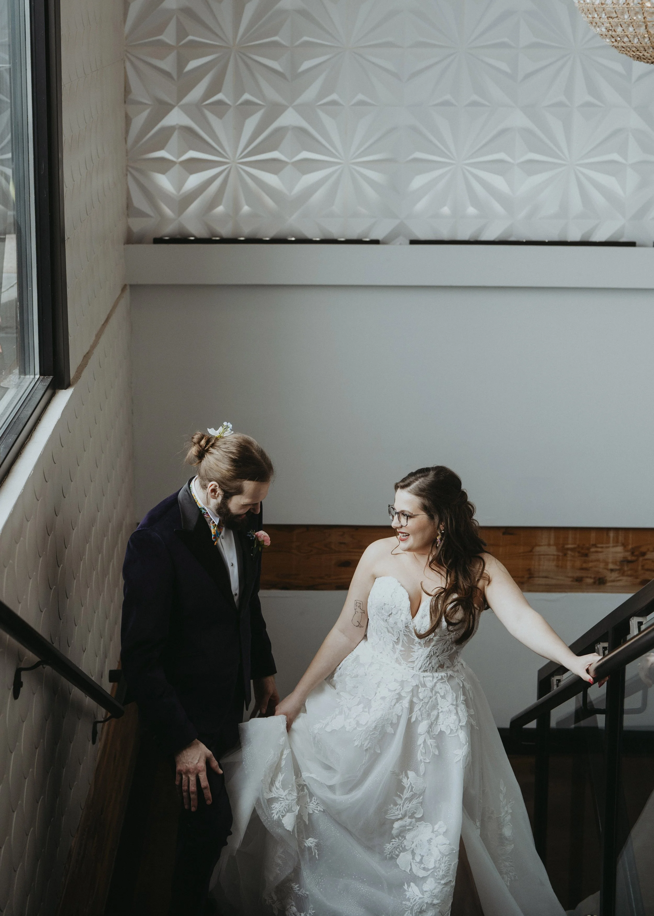 Couple climbs staircase after their wedding ceremony to have a quiet moment alone.