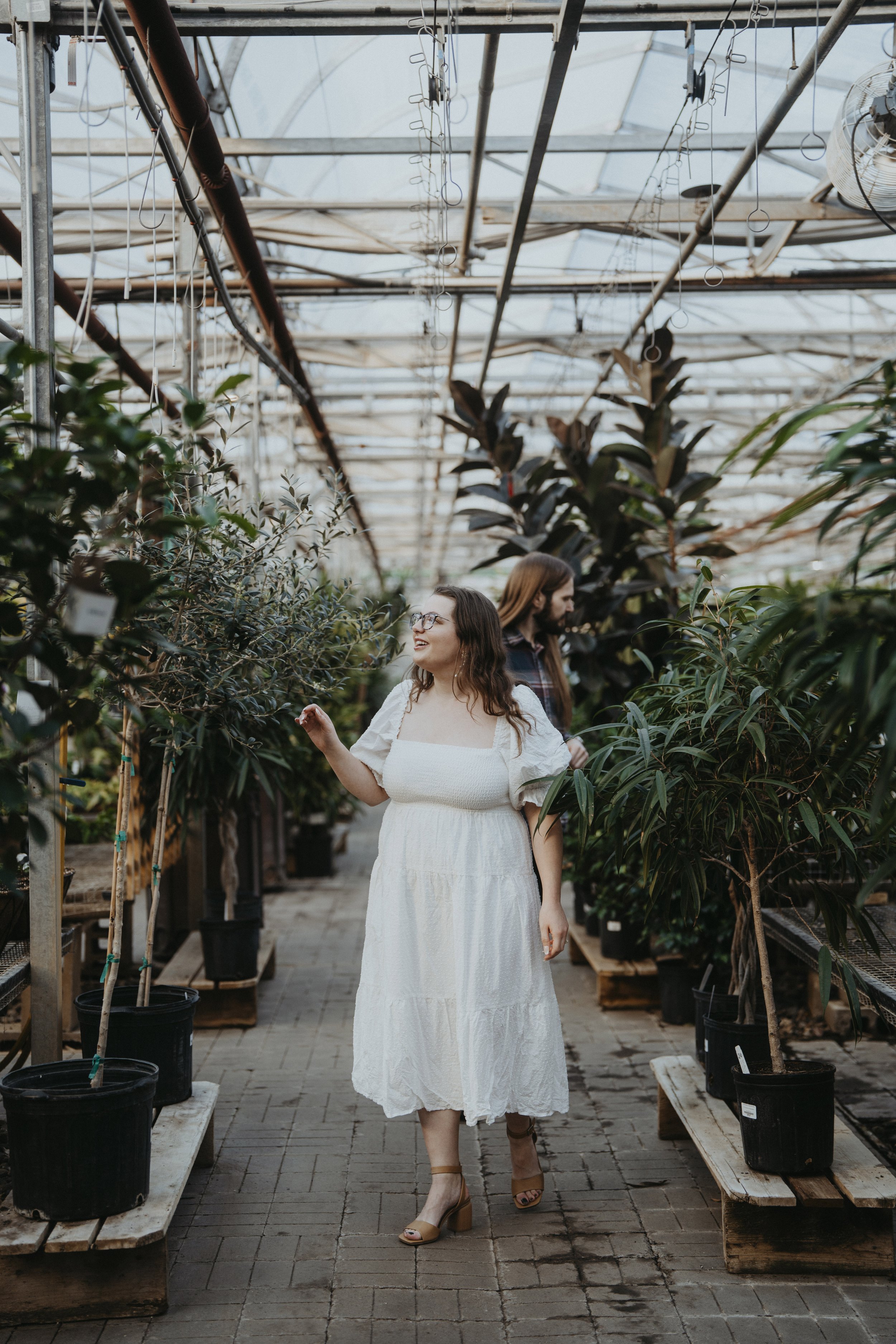 Couple strolling through a green house, engagement session