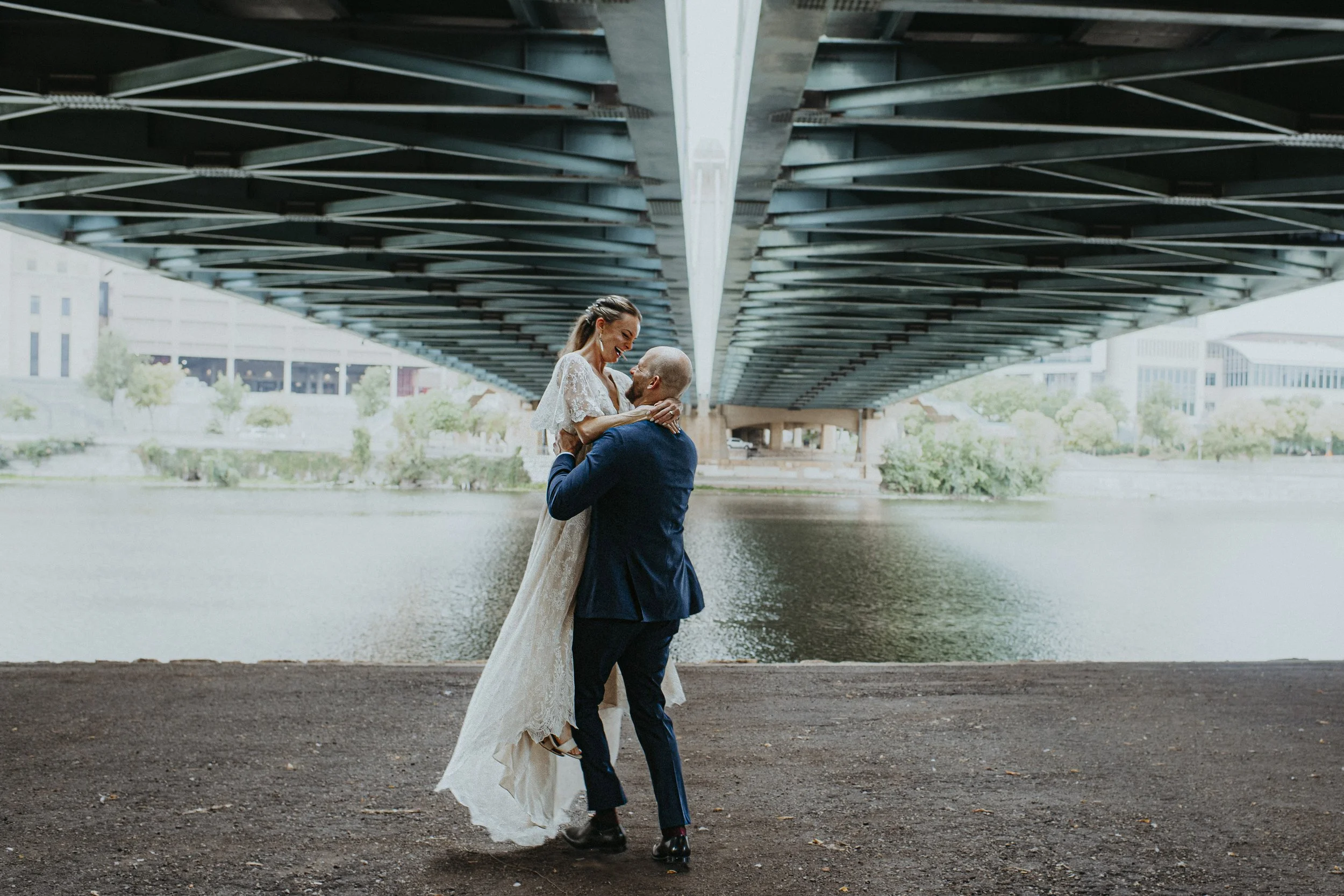 Groom spinning bride around laughing during first look