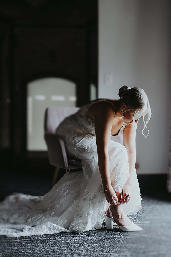 Bride puts her shoes on for Minnesota Wedding at The Essence event venue. Minneapolis wedding venue.