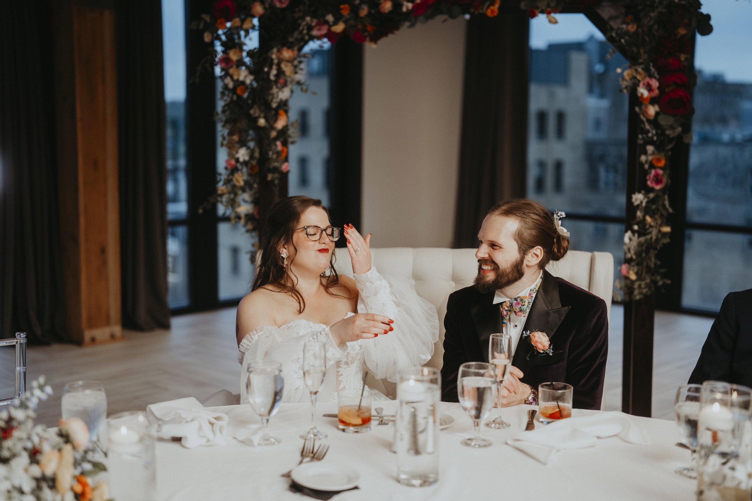 Couple enjoying their cake cutting and laughing.