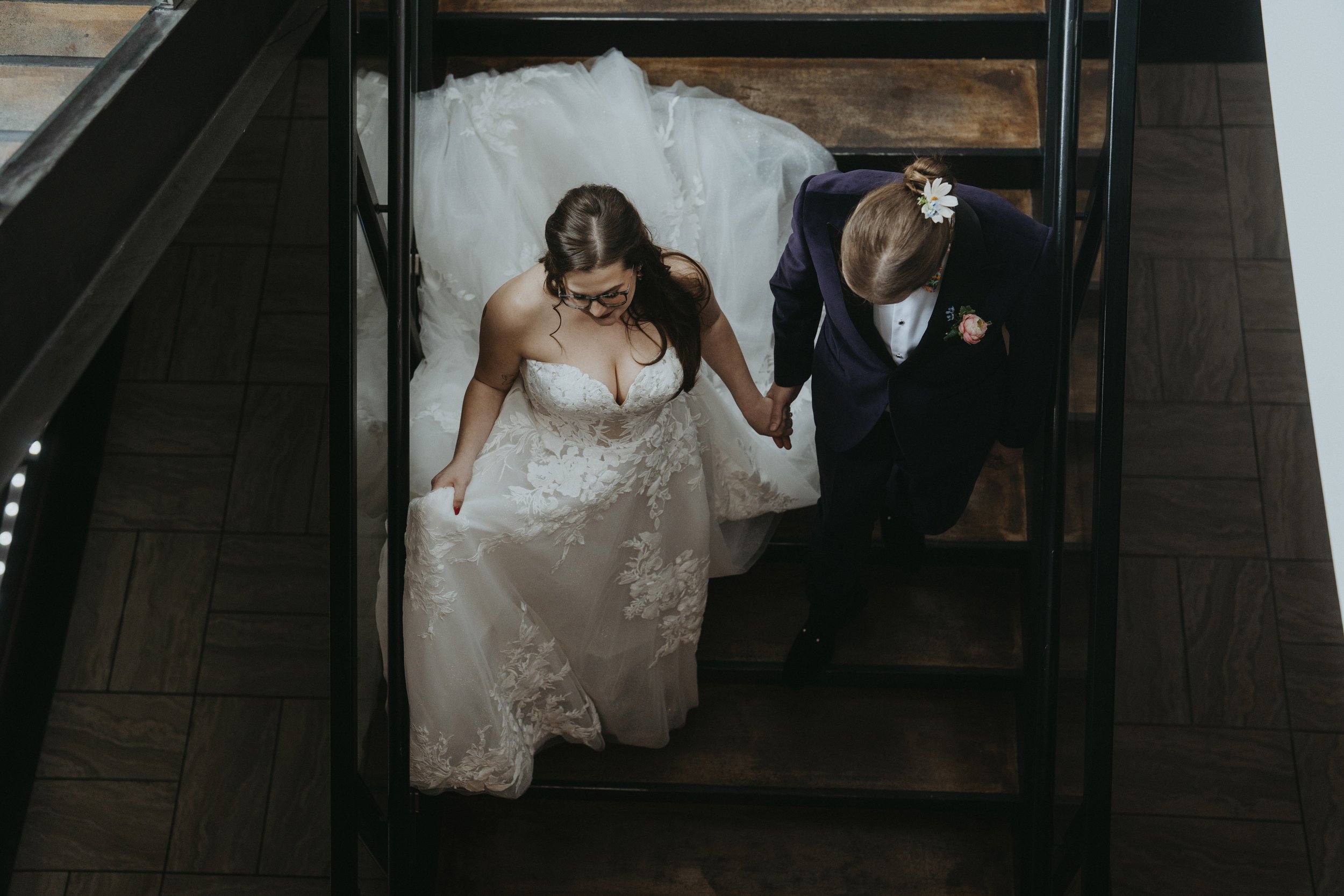 Couple descending staircase after their wedding ceremony
