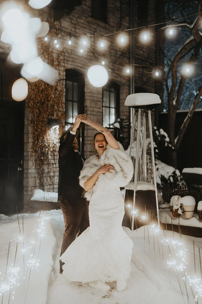 Couple dancing in the snow on their wedding night