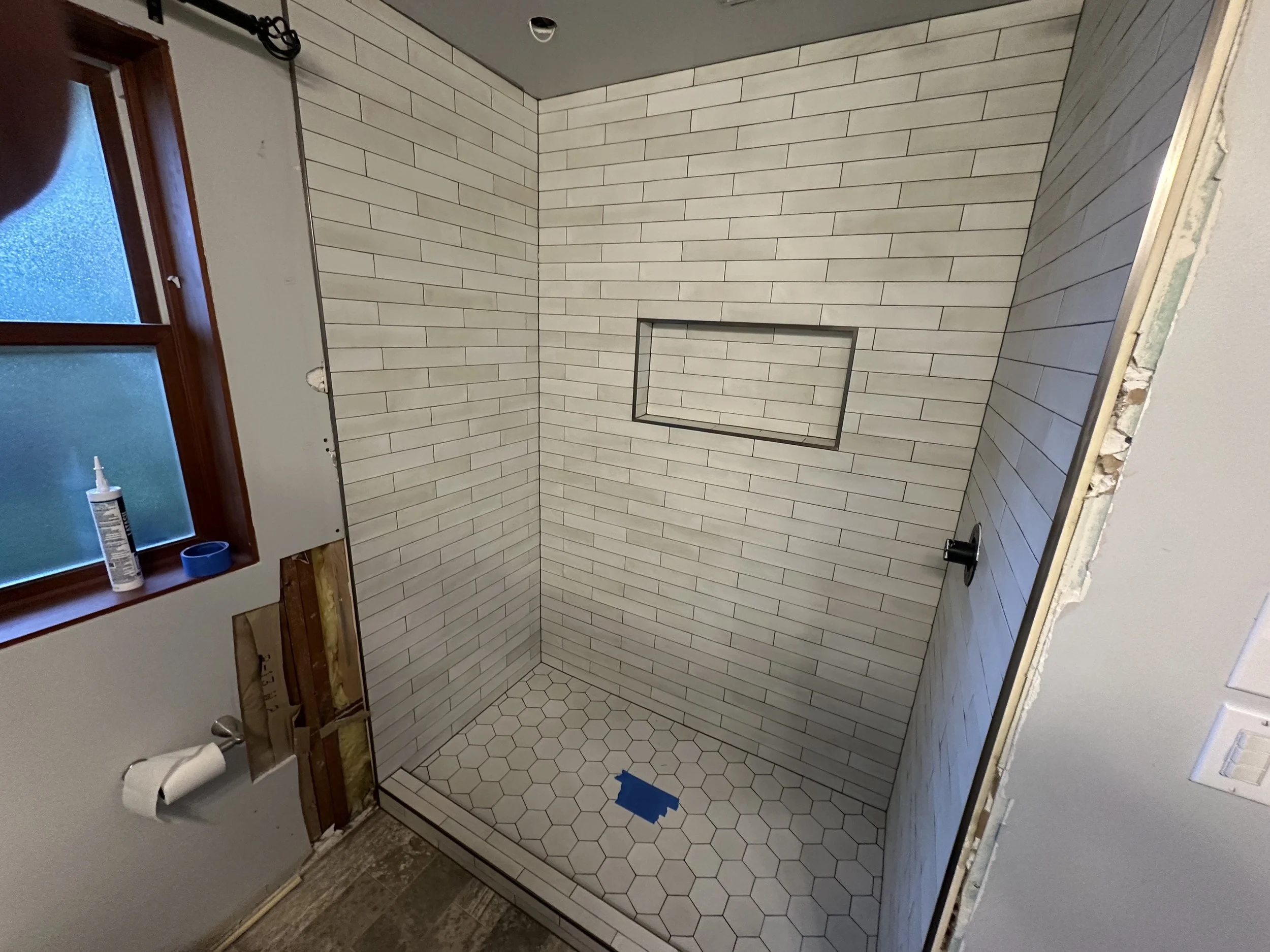 Outdated bathtub before tub to shower conversion in Mercer Island bathroom renovation