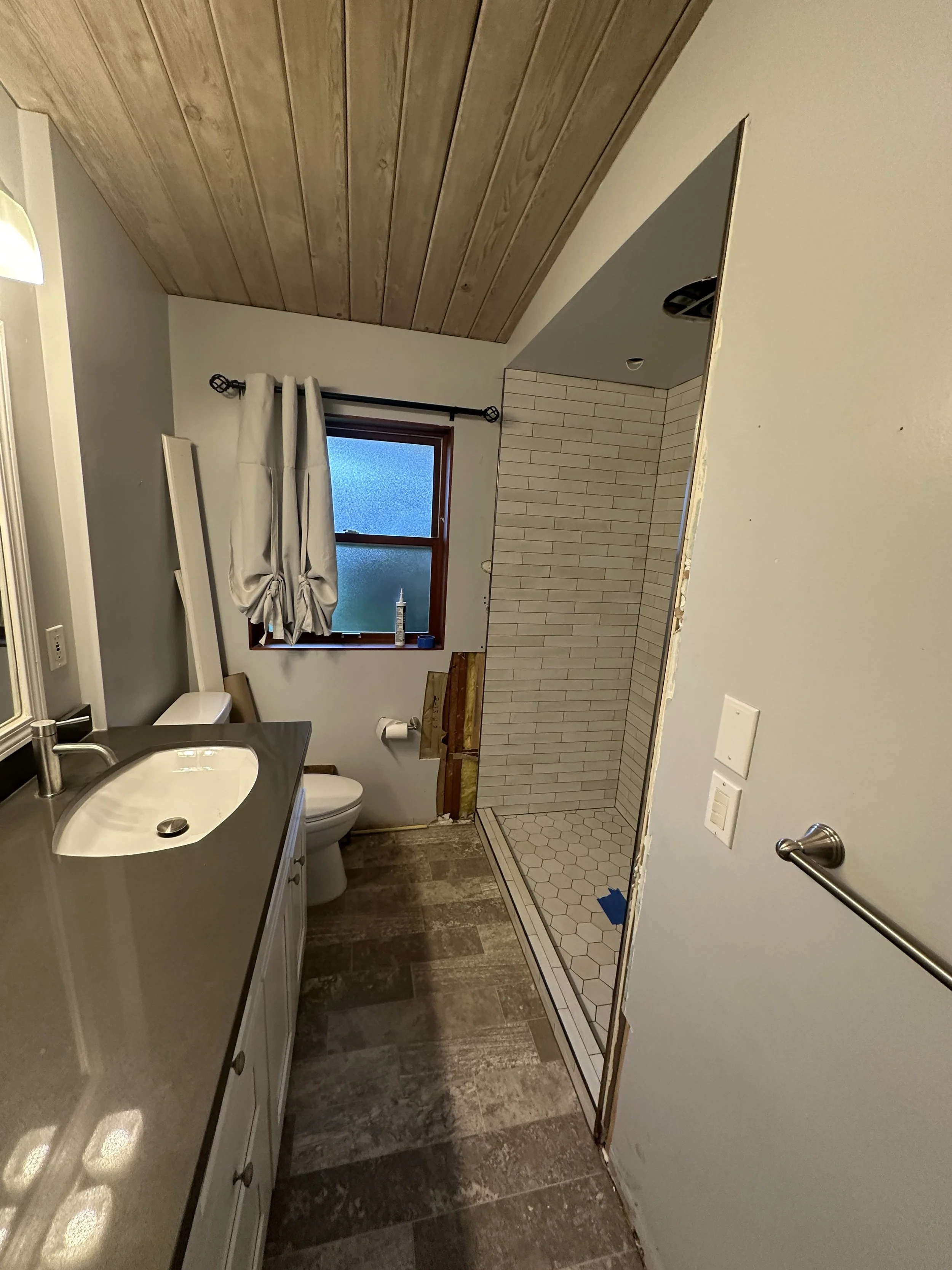 Outdated bathtub before tub to shower conversion in Mercer Island bathroom renovation