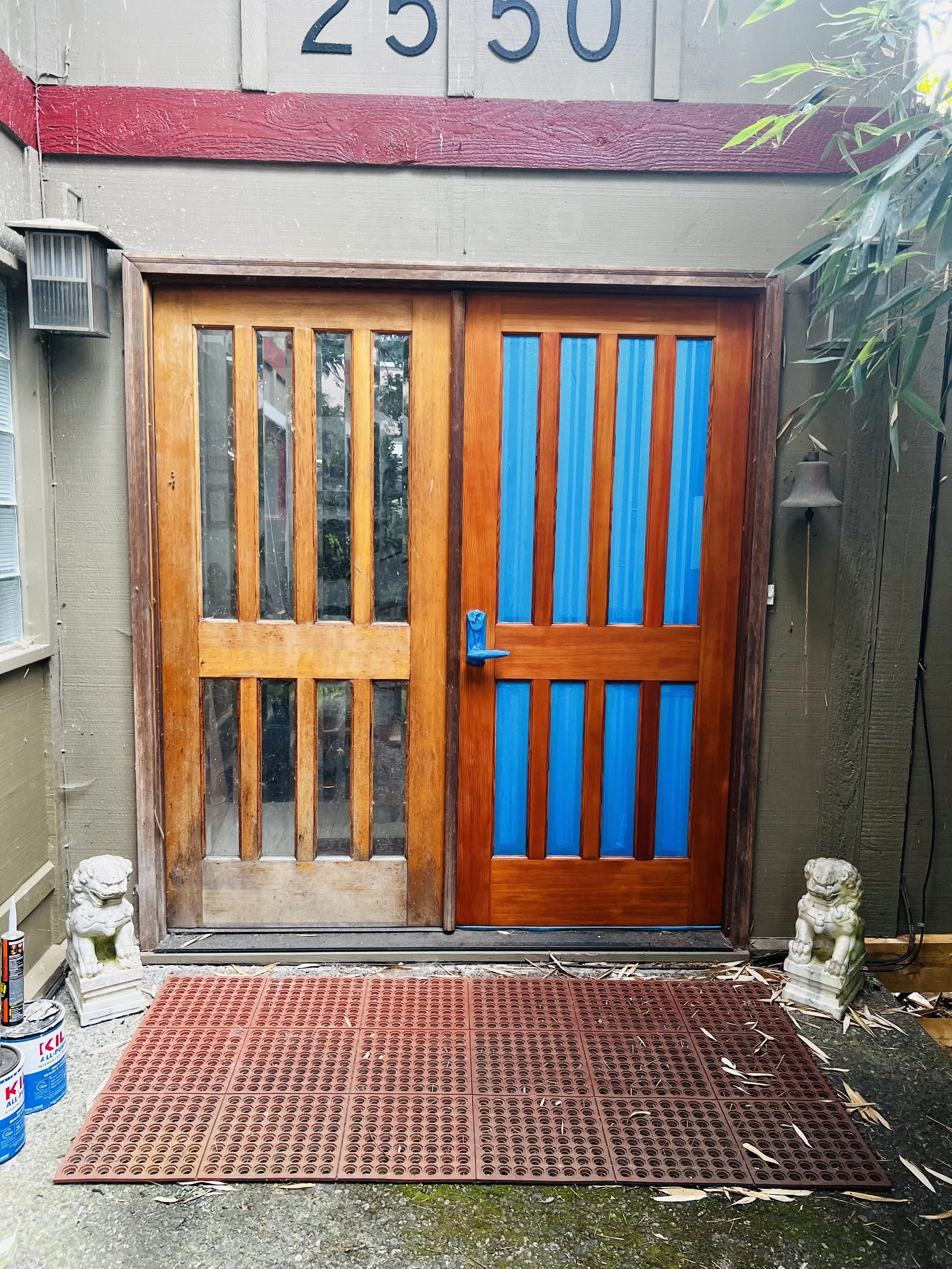 Seattle handyman performing wood door restoration on 20-year-old exterior doors with natural stain