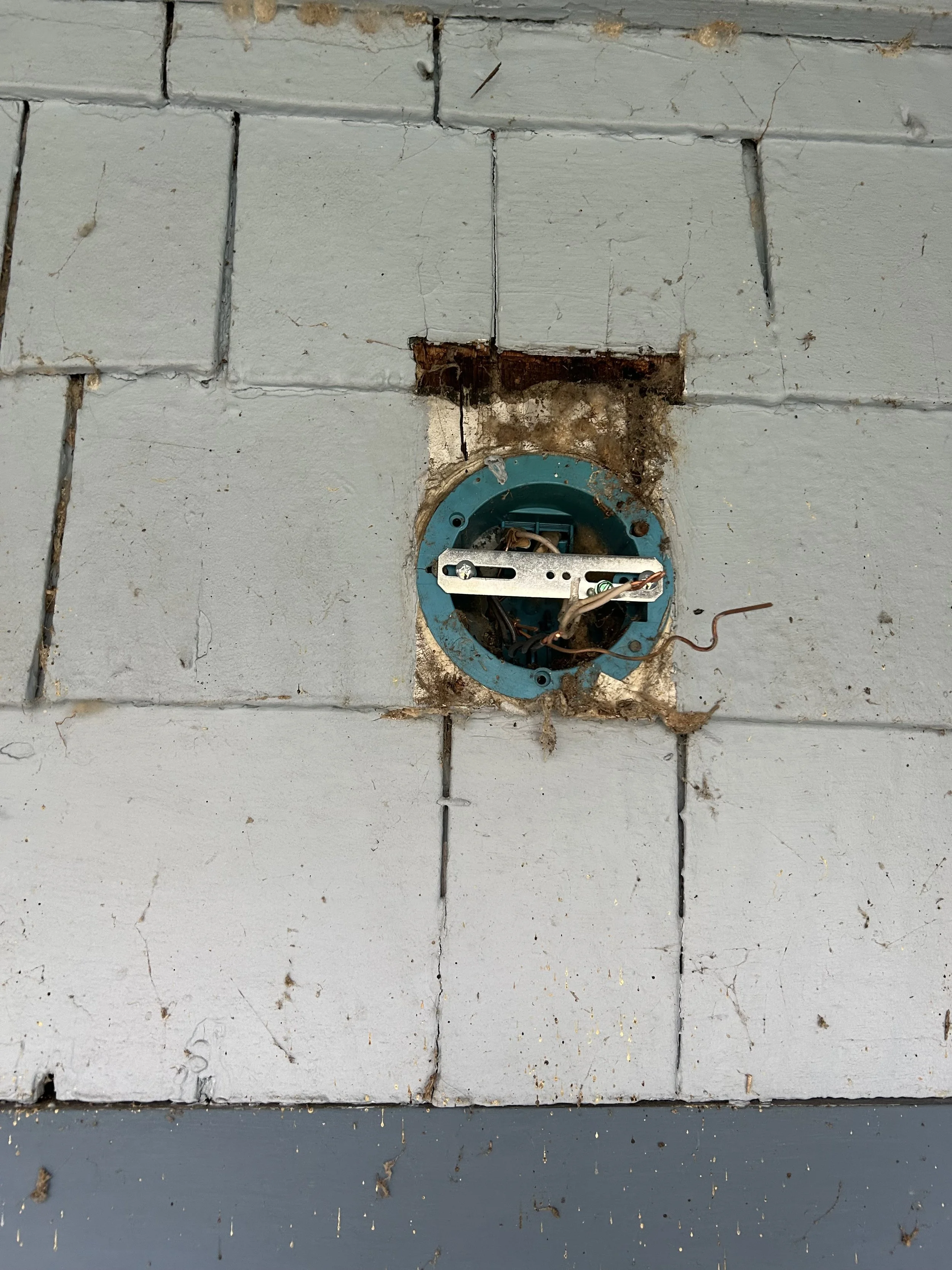 Old outdated outdoor porch light fixture on Seattle area home before replacement by Baklinski handyman services