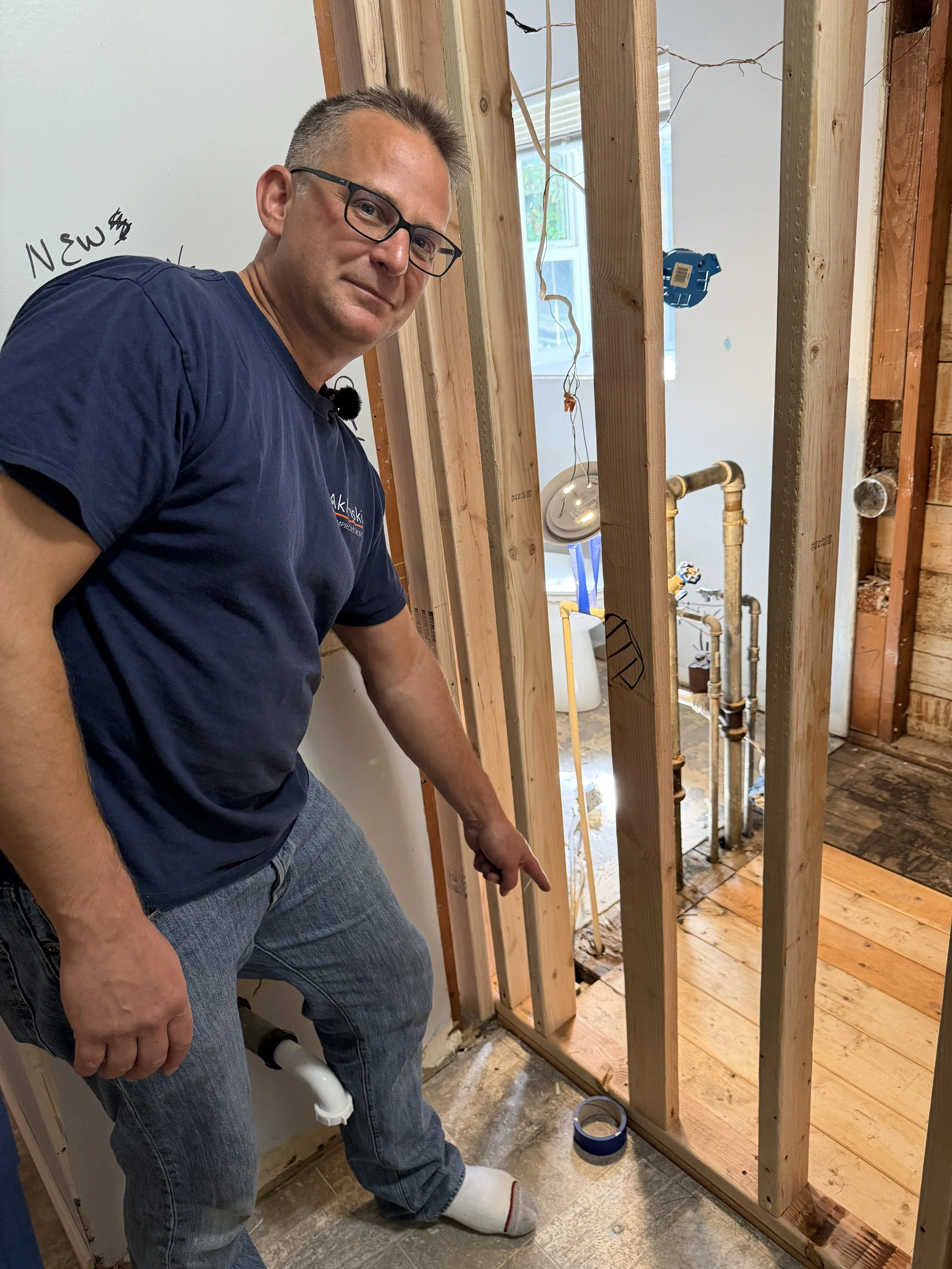 Before/after photo of dryer vent area turned into stylish shower