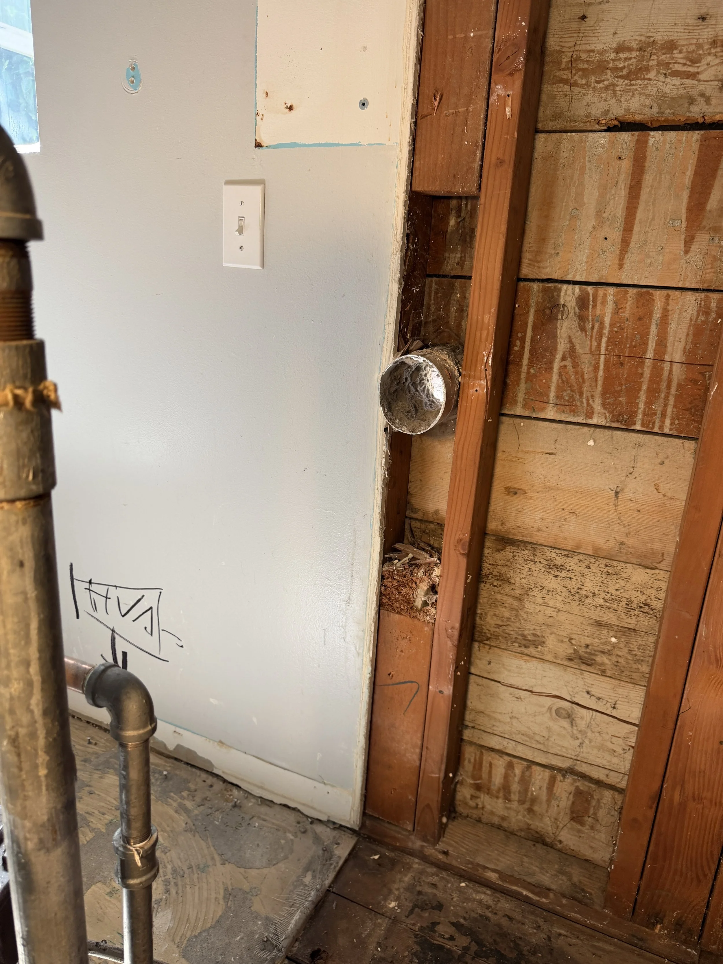 Before/after photo of dryer vent area turned into stylish shower