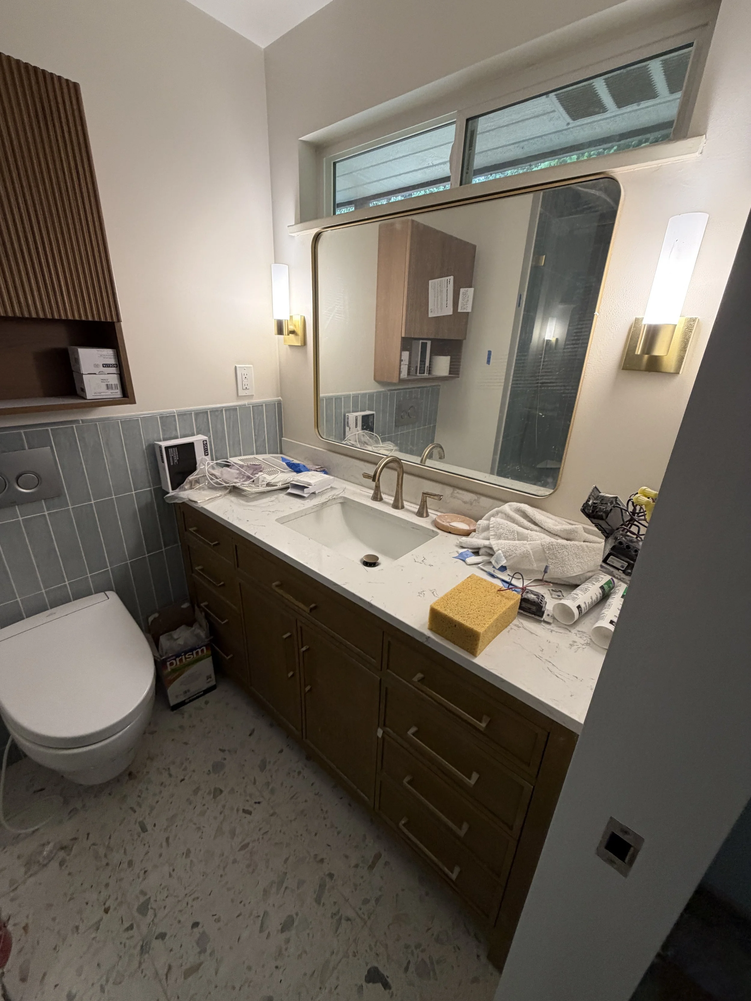 Open glass shower and pocket door in small bathroom remodel Seattle area by Baklinski Home Improvement