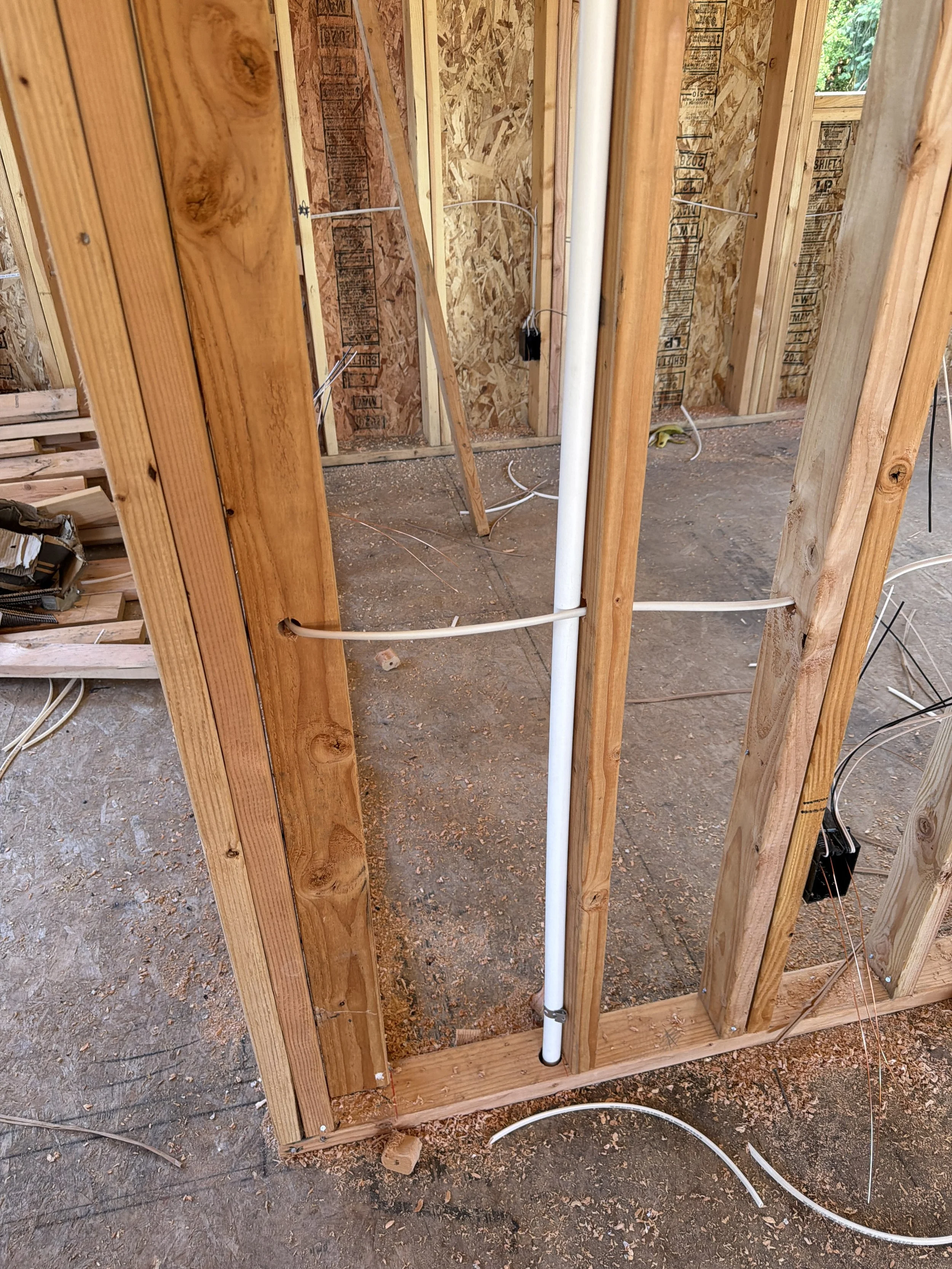 HVAC venting running through second-story addition toward exterior heat pump in Bellevue-area project