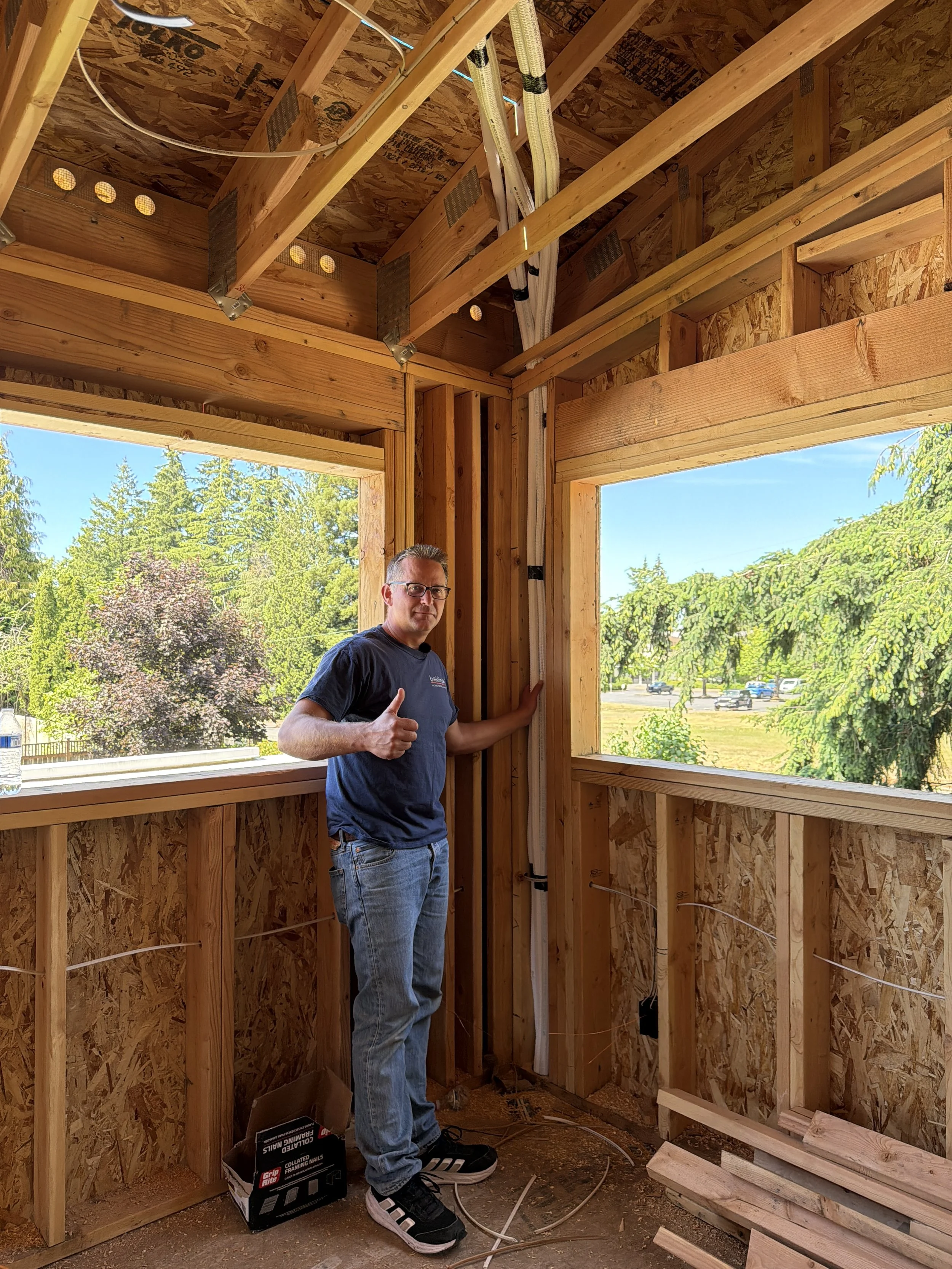 Electricians installing 14-gauge wiring and grounded switches in a Seattle home addition