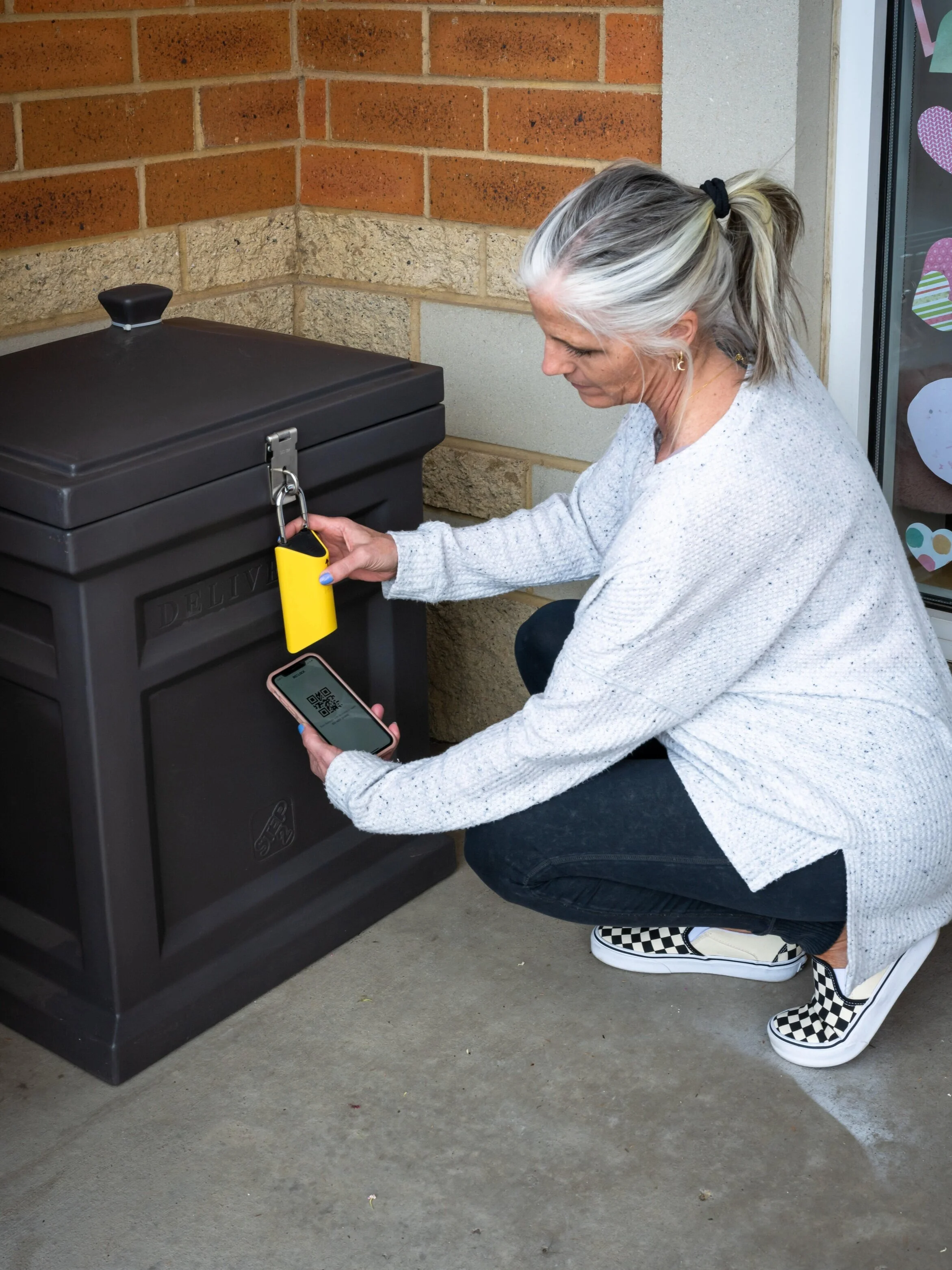 A customer uses BoxLock and their unique QR code to retrieve their order.