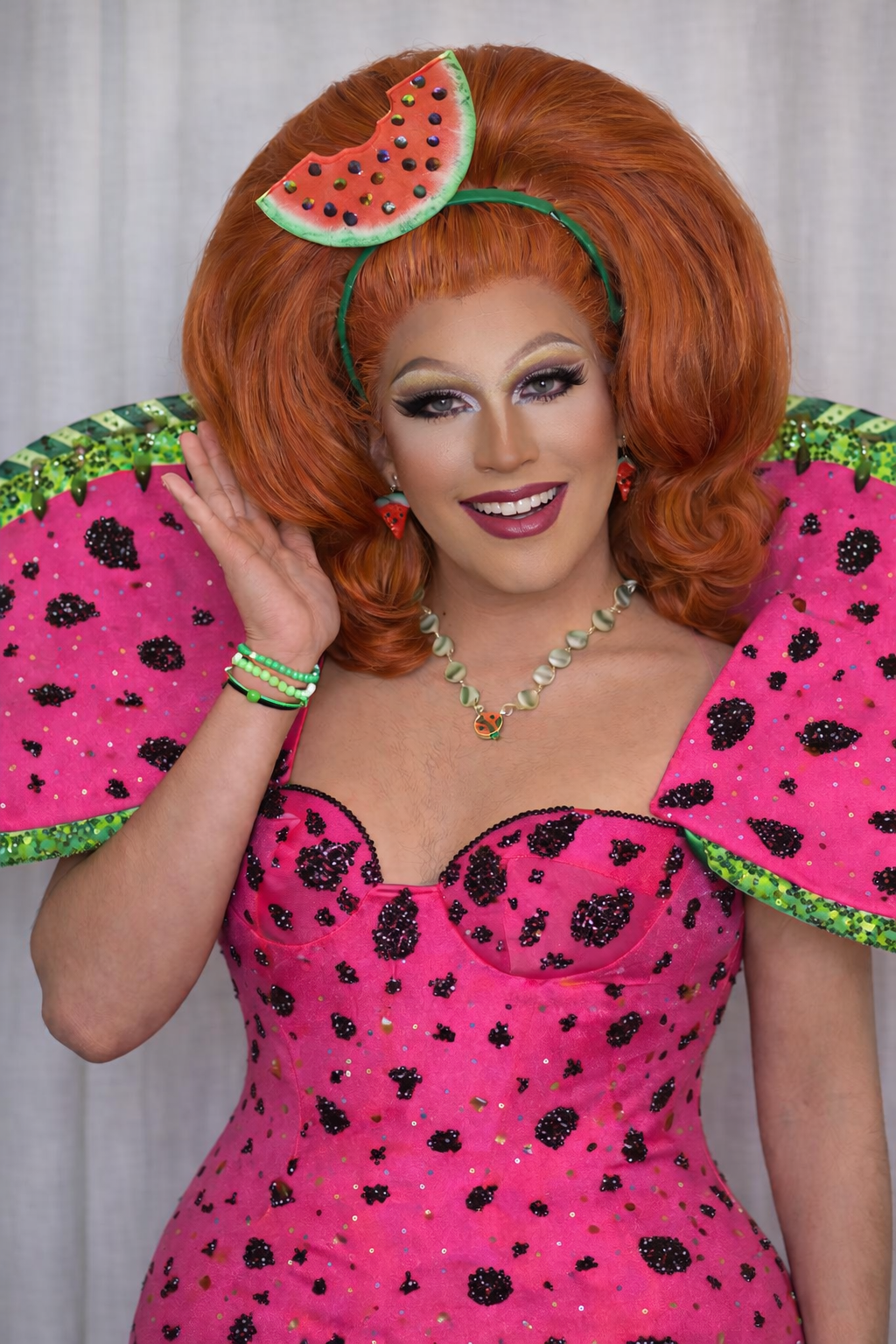 Red head drag queen dressed in a watermelon printed dress