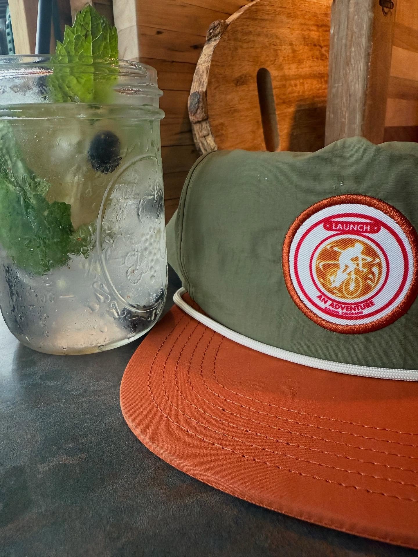 New cocktails and new merch for summer at Launch! Like this Nightshade Mojito with rum, blueberries and mint; and our new cycle-latte caps!