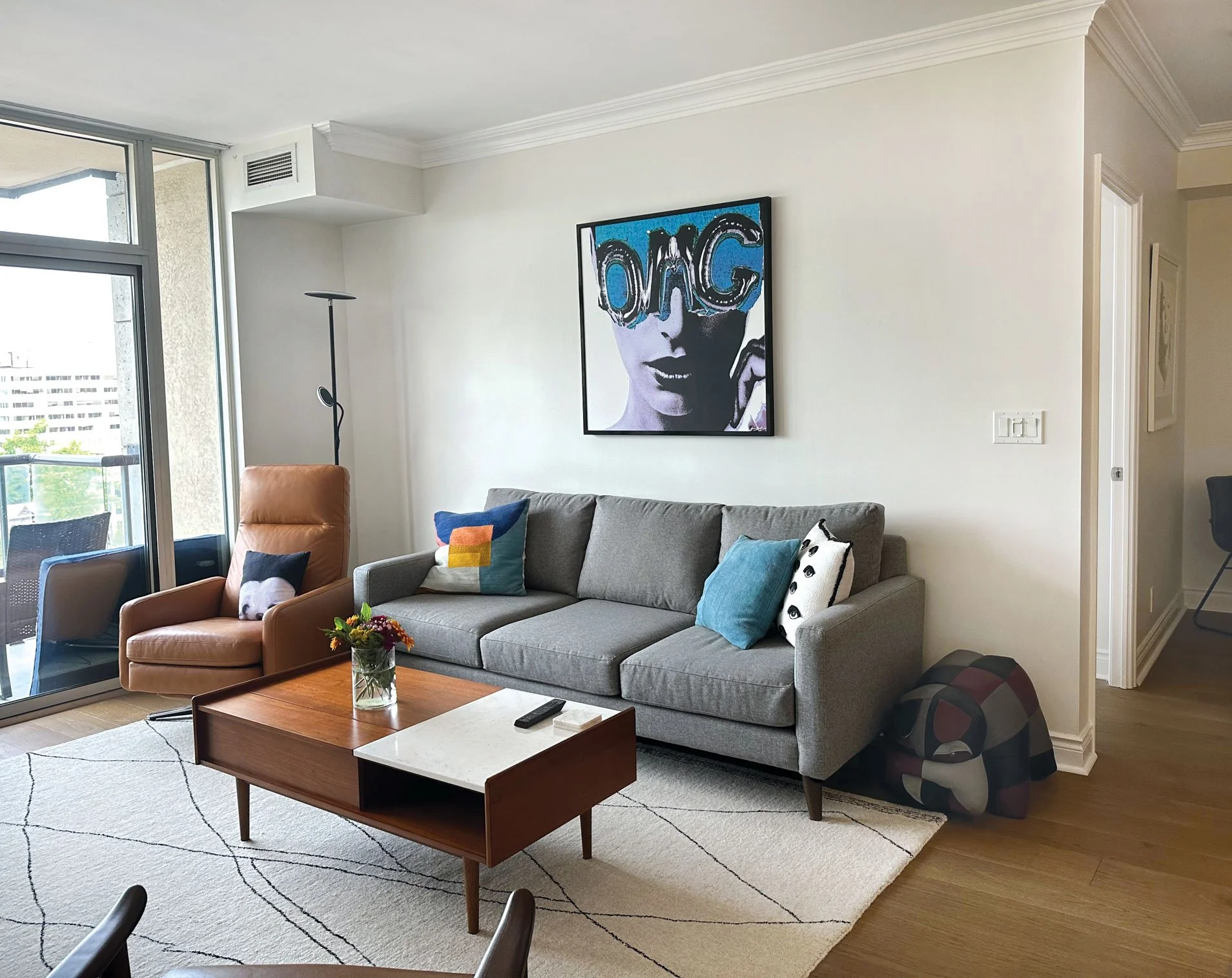 • Moved OMG art from dining room. Blues tie in with pillows.
• Was no prior lighting. I took extra light from office. Black colour picks up black in the art, rug, accent pillow.
• Moved rug from dining room as it fit the living room space perfectly.