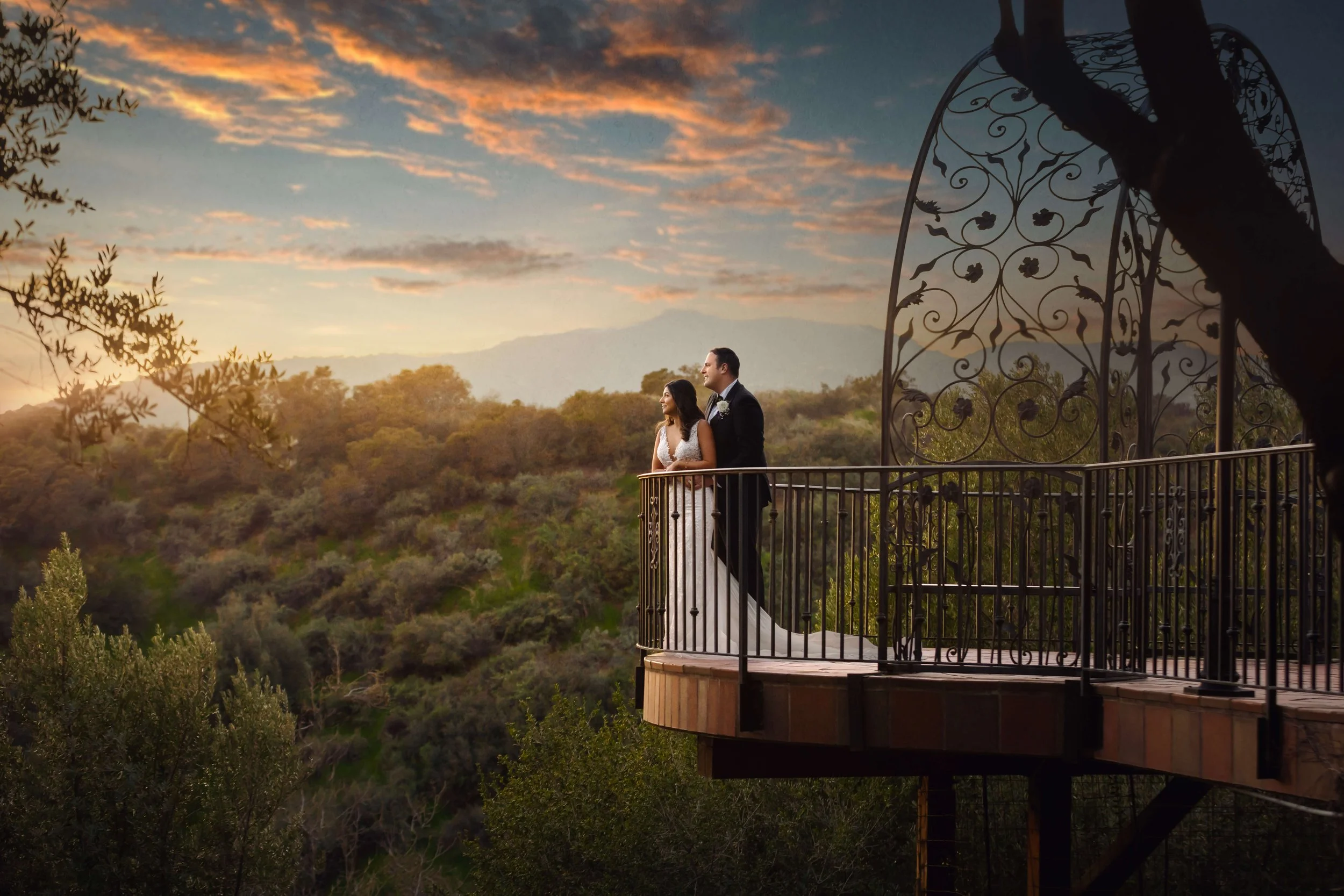 Bride and Groom hugging while overlooking the balcony at Padua Hills Theatre.