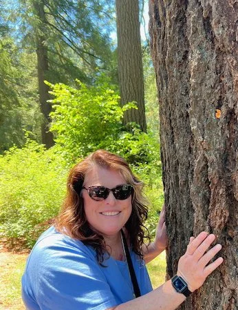 Photo of Melinda Pajak hugging a redwood tree