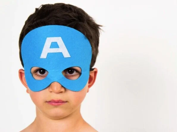 a child with a hero mask denoting the big job that the hero of the family has