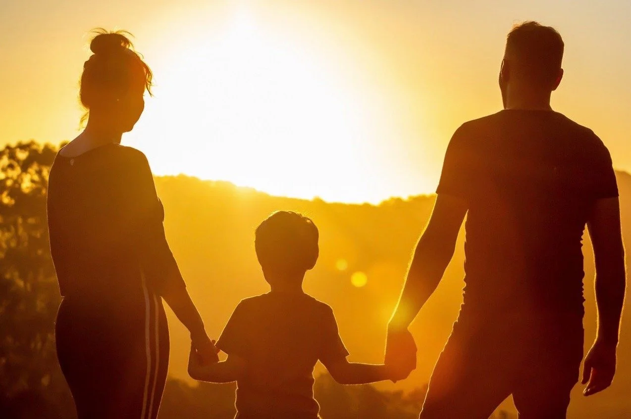 a picture of a small family in the sun