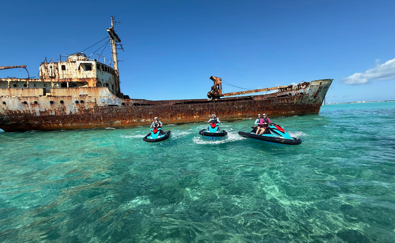 Three jet skis in front of a pirate ship in Turks and Caicos