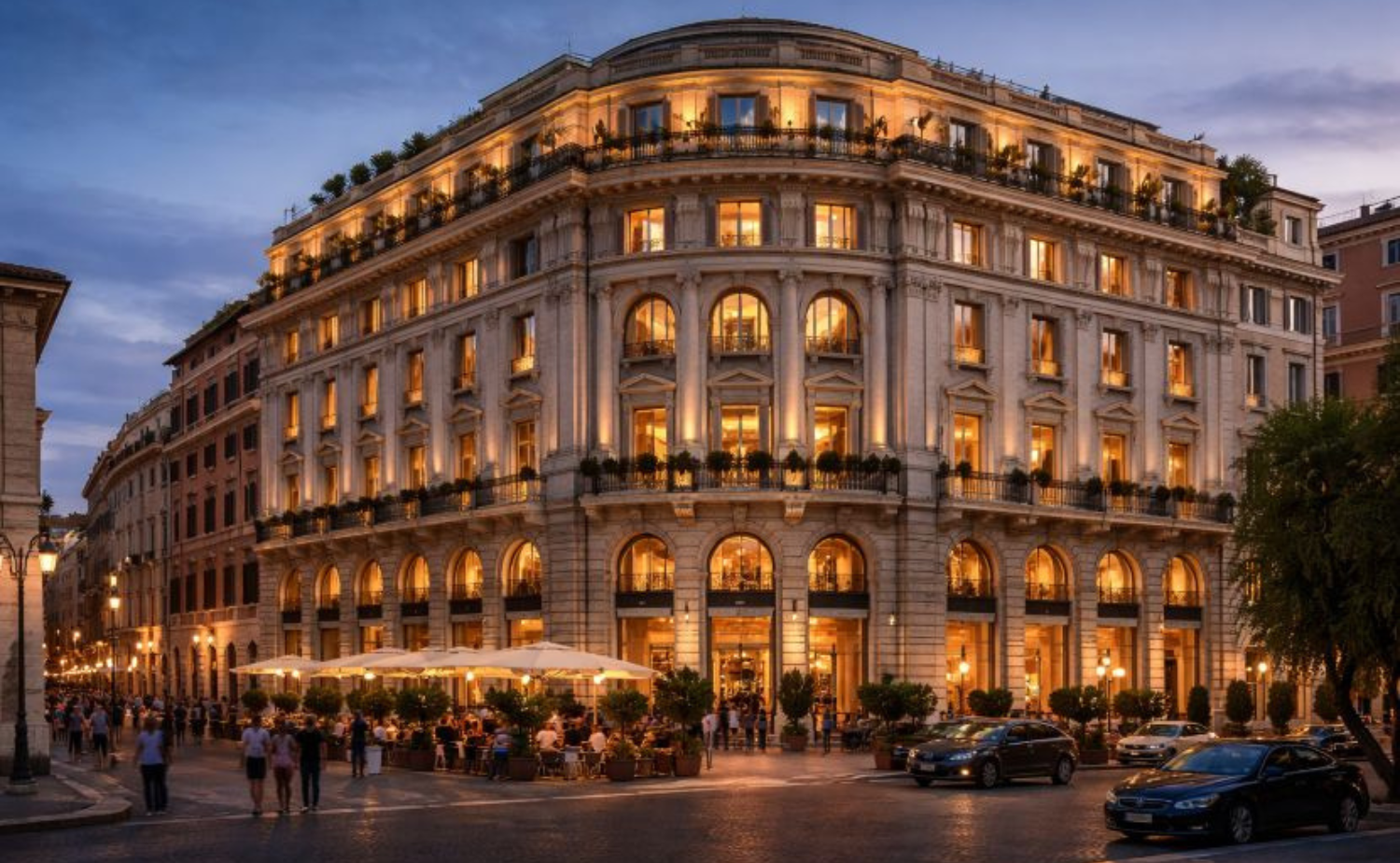 Exterior view of the Corinthia Rome illuminated at dusk, showcasing grand historic architecture in the heart of Rome.