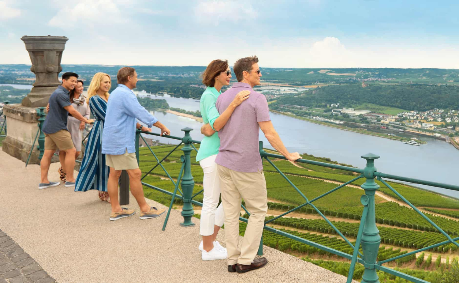 Multiple generations of travelers overlooking a river valley during a European river cruise excursion.