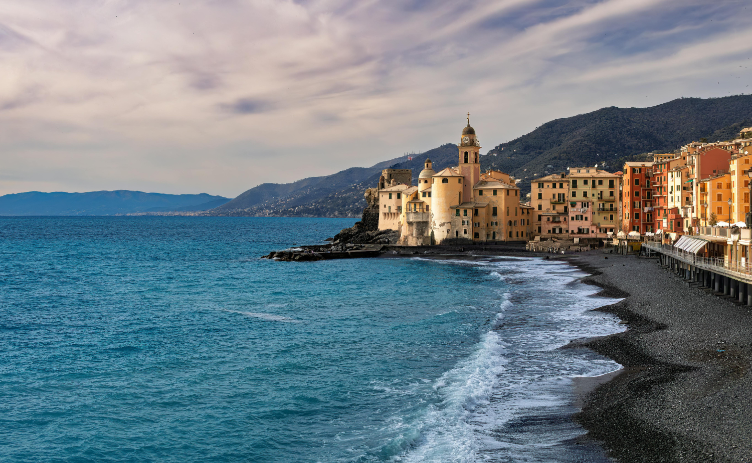 Waterfront view of the colorful fishing village of Camogli along the Ligurian coast in Italy.
