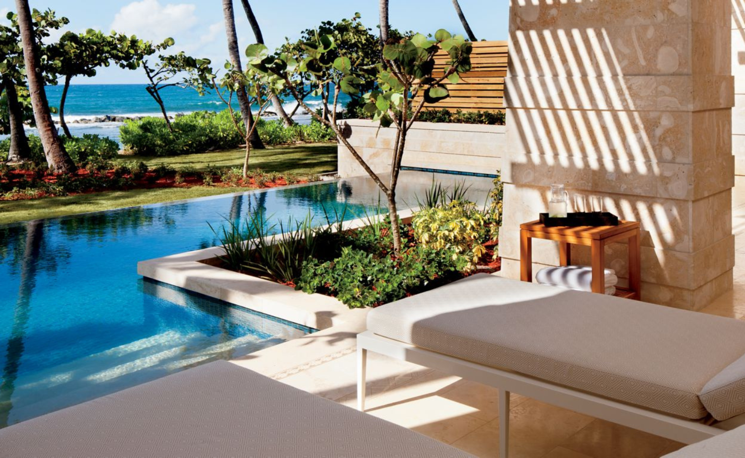 Private villa terrace with plunge pool and ocean views at a Caribbean luxury resort.