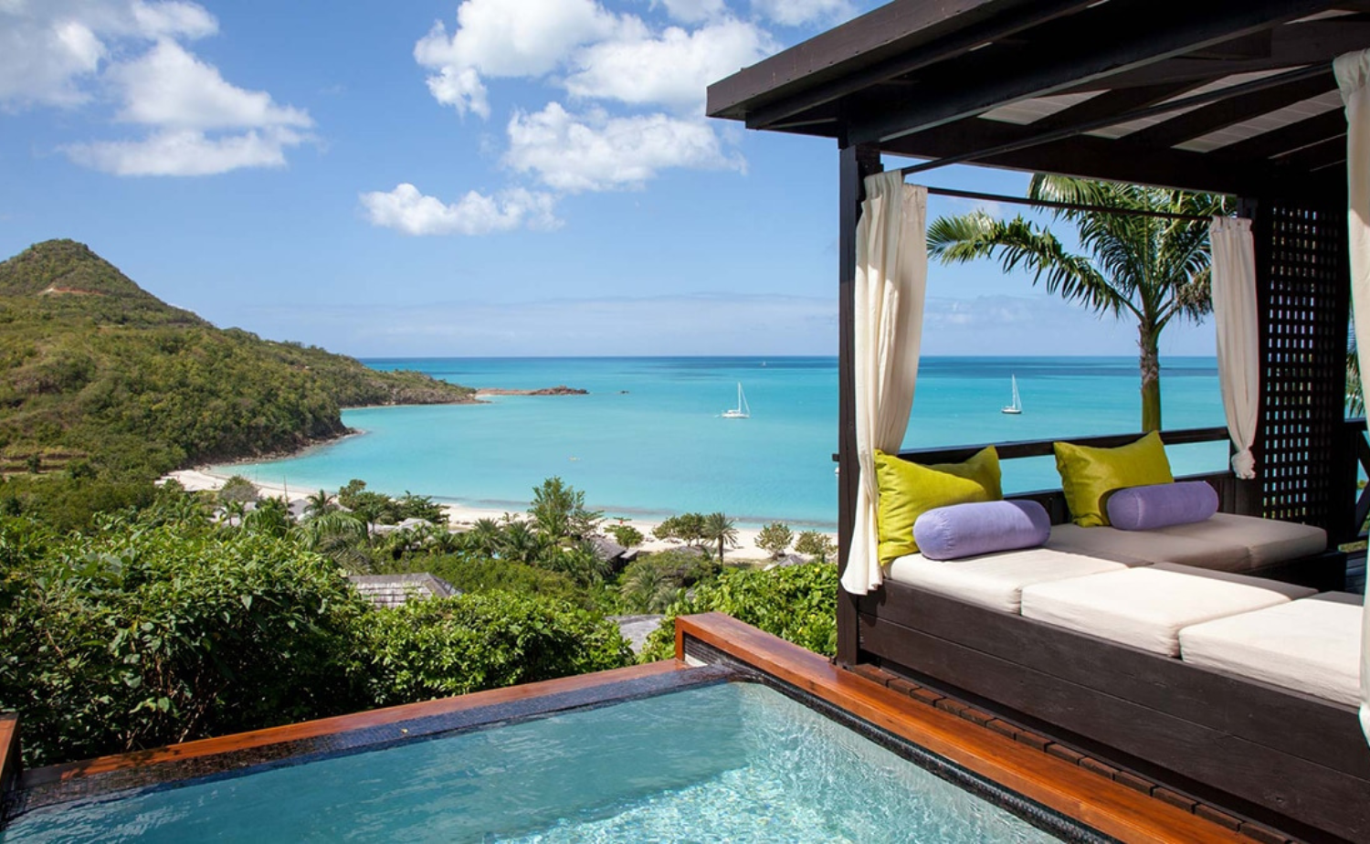 Private plunge pool overlooking a quiet bay and turquoise water at a luxury resort in Antigua.