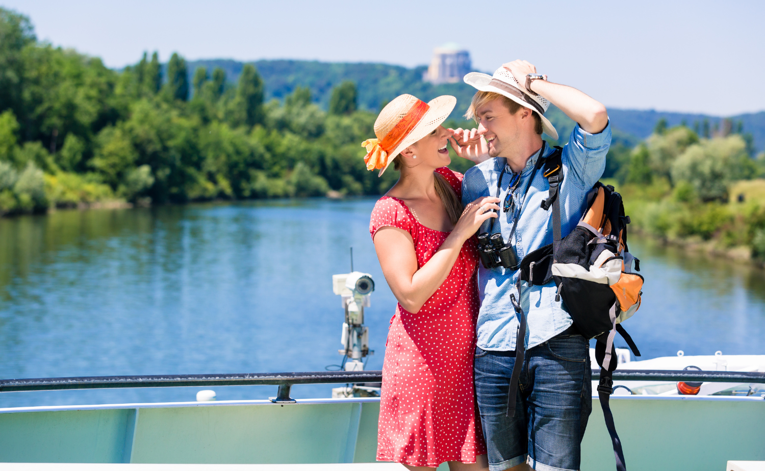 Couple enjoying scenic river views from the deck of a European river cruise ship.