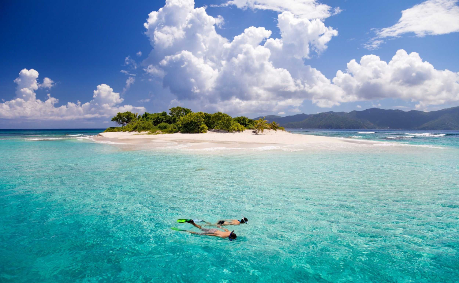 Snorkelers exploring the clear turquoise water surrounding Carriacou, Grenada.