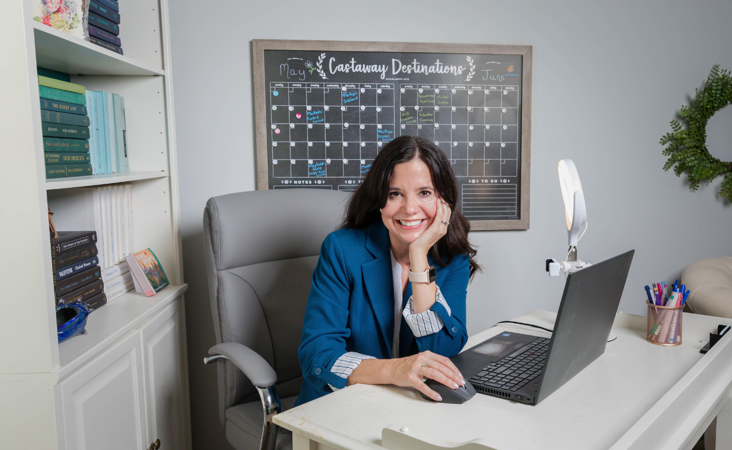 Laura Legg, owner of Castaway Destinations, working from her home office while planning custom vacations for clients.
