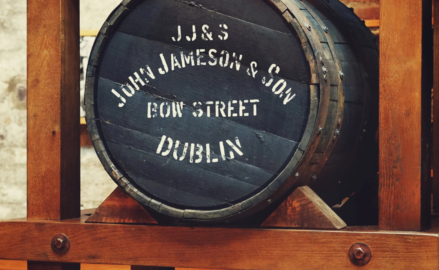 Interior view of whiskey distilling equipment inside a historic Irish distillery.