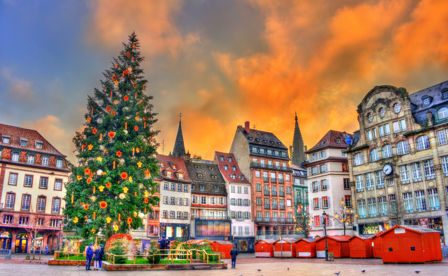 Strasbourg's historic Christmas market with a towering decorated Christmas tree surrounded by festive market stalls in Alsace, France