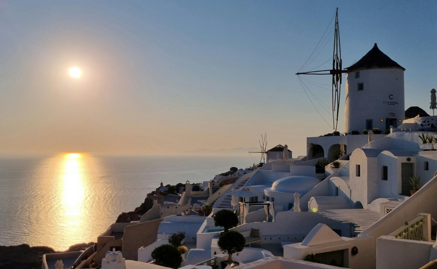 Traditional white windmill overlooking the Aegean Sea at sunset on Amorgos in the Cyclades