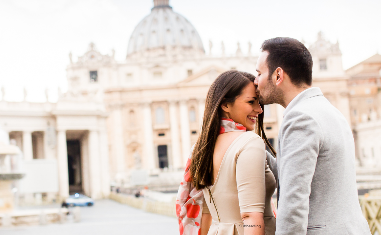 Man kissing a smiling woman on the forehead near St. Peter’s Basilica