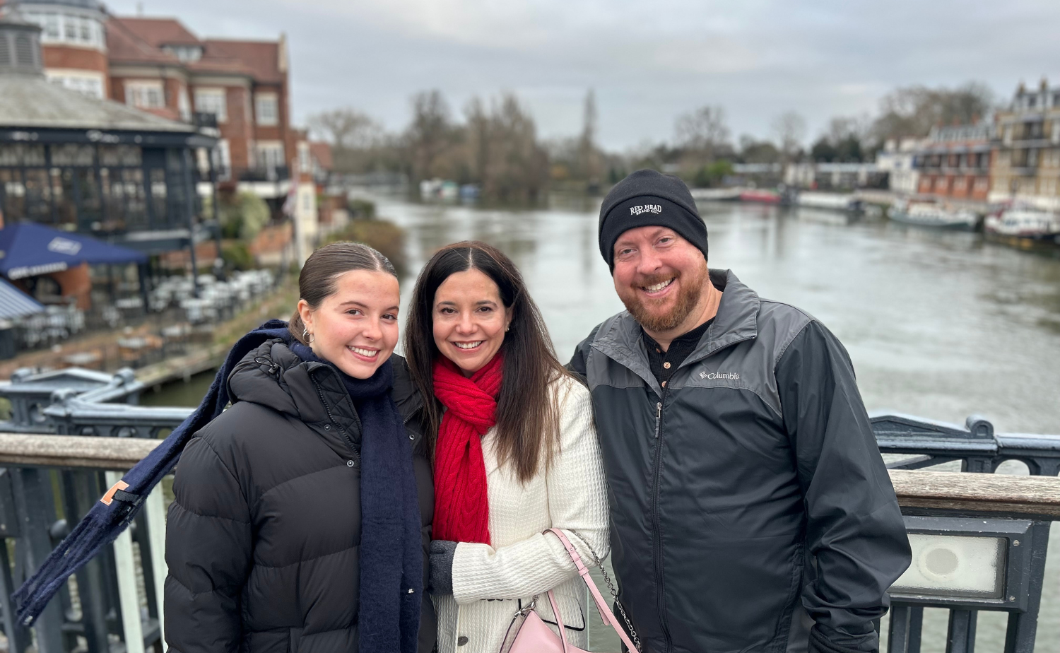 Family standing along the River Thames in London on a winter day.