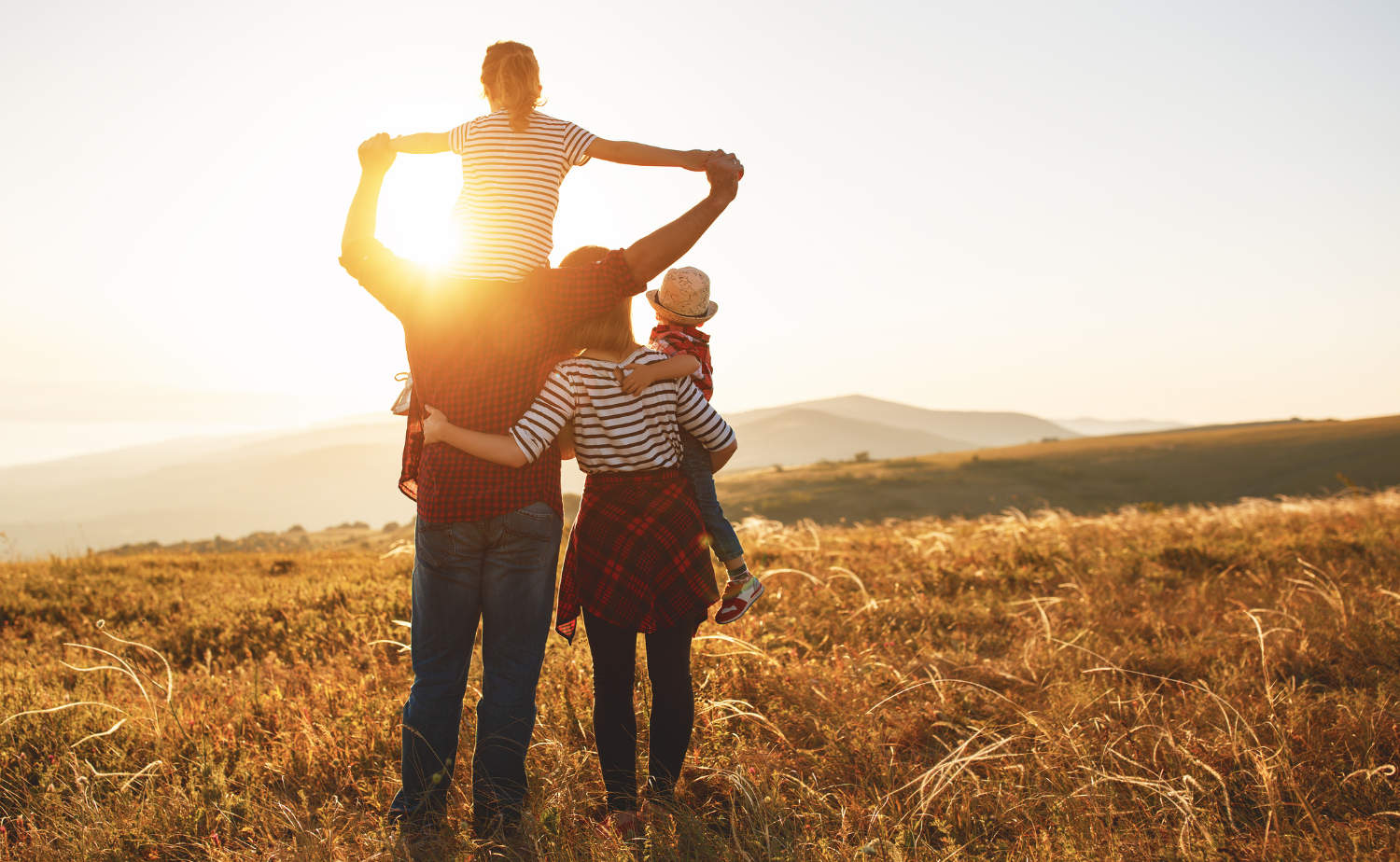 A family with two small children at golden hour