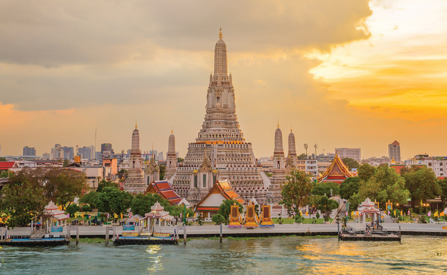 Wat Arun along the river in Bangkok, Thailand, at sunset.