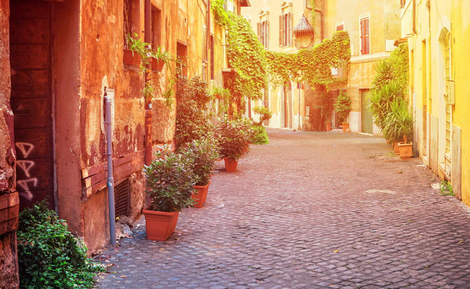 St. Mark’s Square in Venice at sunrise with empty café seating and historic architecture glowing in soft morning light.