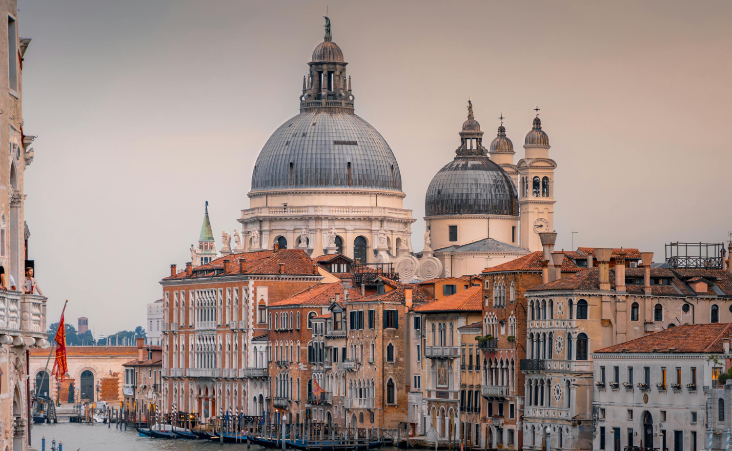 View of the Grand Canal in Venice, Italy with historic buildings and the dome of Santa Maria della Salute in the background