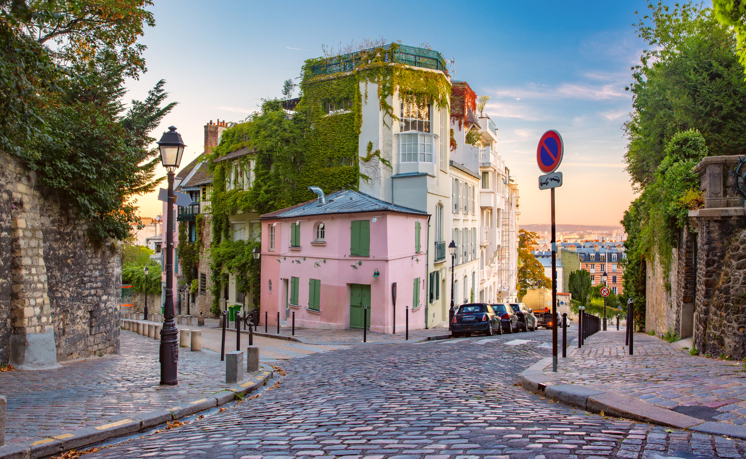 Quiet Paris street with colorful buildings and cobblestone road in Montmartre.