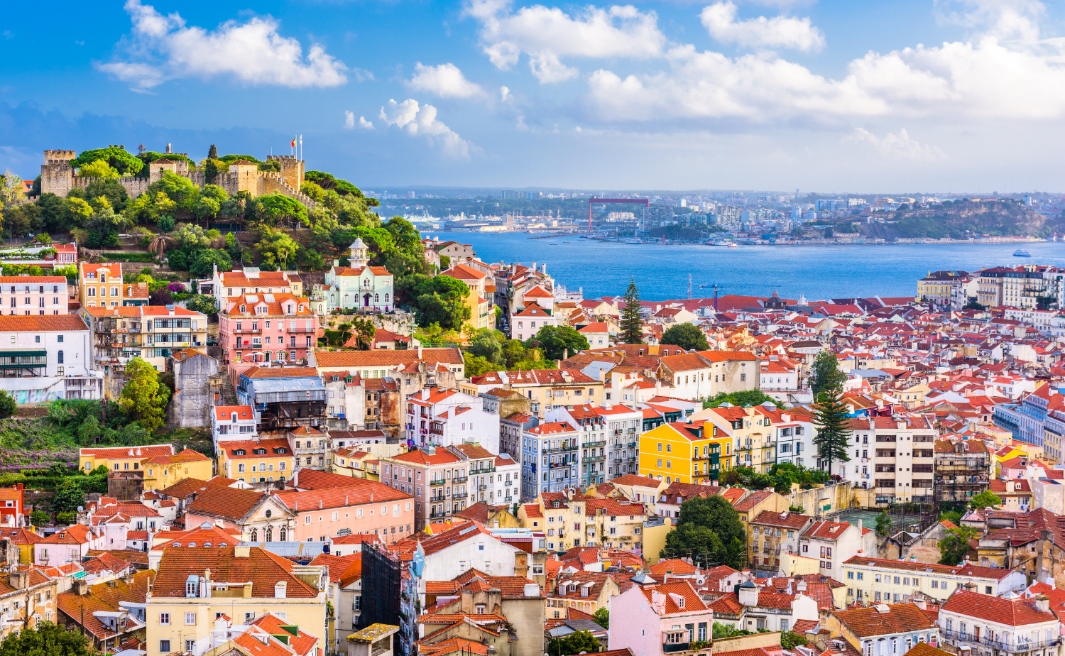 Colorful rooftops and historic neighborhoods overlooking Lisbon, Portugal.