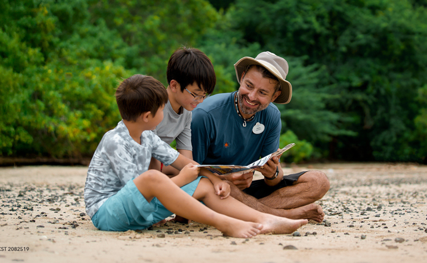 Adventure Guide sharing an outdoor activity with two children during an Adventures by Disney family vacation.